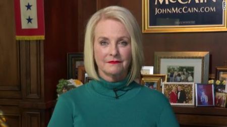 Cindy McCain  in a green sweater poses for a picture.